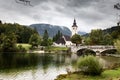 Church steeple building old bridge, Bohinj lake Slovenia Royalty Free Stock Photo