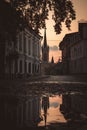 Church steeple, rising above a puddle on a city street