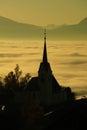 A church steeple is silhouetted against a foggy sky Royalty Free Stock Photo