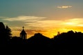 Church steeple silhouetted against a sunset