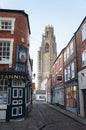 Cobbled street with a church tower in the background DEC 2019: