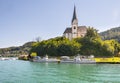 Church with tourist boats on Worthersee at Maria Worth, Carinthia, Austria