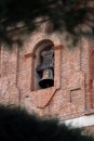 Church tower with bell in the village