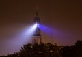 The church tower of Hamburg\'s Michel glows blue at night, like a lighthouse