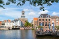 Church tower and outdoor cafe on Rhine canal, Leiden, Netherlands