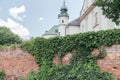Church Tower Peering Above Ivy-Covered Wall Royalty Free Stock Photo