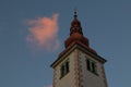 Church tower with sunlit cloud