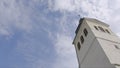 Church tower on a sunny day. Action. White Church steeple on background of blue sky Royalty Free Stock Photo
