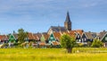 Church towering above Village with colorful wooden houses Royalty Free Stock Photo