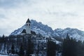 Church and trees on snow covered mountain with sky in background Royalty Free Stock Photo