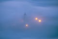 Church under fog at night in Aramaio