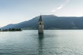 Church under water, drowned village, mountains landscape and peaks in background. Reschensee Lake Reschen Lago di Resia. Royalty Free Stock Photo