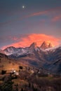 Church in a village in the french alps with mountains 3000 meters high. Green meadows in spring