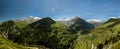 Church in a village in the french alps with mountains 3000 meters high. Green meadows in spring. drone panning