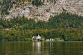 Church in the village at Lake Hallstatt under a high rock and re