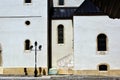 church wall part elevation. stone stair and arched windows. stucco facade. cobblestone road