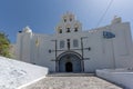 Church with white bell tower in Pyrgos Kallistis, Santorini island