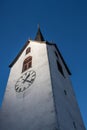 a churchtower with blue sky in background