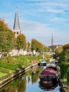 Churchtower, chimney and Eegracht canal in IJlst, Friesland, Netherlands