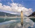 Churchtower reflects in the Lake Reschen, Curon Vinosta, Vinschgau, Italy