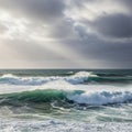 Frothy whitecaps, and sunlight filters through the clouds, casting Royalty Free Stock Photo
