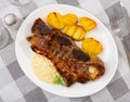 Churrasco style grilled veal ribs with potatoes and sauce Royalty Free Stock Photo