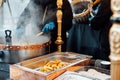 Churreria cooking churros on street market. Churros is a traditional Spain street fast food. Selective focus, copy space