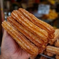 Churro Sticks in Hand, Churros Pastry, Fried Spanish Dessert, Churro Sticks Closeup, Copy Space