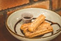 Churros Fried Spanish donuts x4 stacked and served with chocolate dip in a bowl Royalty Free Stock Photo