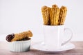 Churros in a mug, traditional fried sweet from Latin America, Brazil, Colombia, United States and Portugal, served with or without