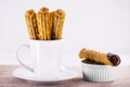 churros in a mug, traditional fried sweet from Latin America, Brazil, Colombia, United States and Portugal, served with or without