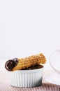 churros in a mug, traditional fried sweet from Latin America, Brazil, Colombia, United States and Portugal, served with or without