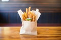 churros in a paper bag with a window, to-go style