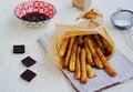 Churros, sweet fried fried choux pastry dough, sprinkled with sugar and ground cinnamon. Served with chocolate sauce. Traditional