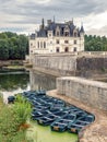 The ChÃÂ¢teau de Chenonceau, medieval castle in the Loire Valley in France. Parked boats at the pier in the foreground. Royalty Free Stock Photo