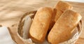 ciabatta bread in basket on wooden background. Royalty Free Stock Photo