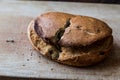 Ciabatta Bread split in two pieces on wooden surface Royalty Free Stock Photo