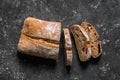 Ciabatta. Dark fresh healthy flattish open-textured Italian bread on black rustic background. Close-up. Top view Royalty Free Stock Photo