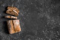 Ciabatta. Dark fresh healthy flattish open-textured Italian bread on black rustic background. Close-up. Top view Royalty Free Stock Photo