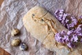 Ciabatta with olives in baking paper. Italian homemade wheat bread, quail eggs, lilac flowers