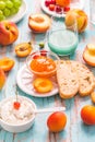 Ciabatta with peach and apricot jam, ricotta cheese, fruits and smoothie