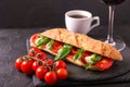 Ciabatta sandwich with caprese salad with wine and coffee. Royalty Free Stock Photo