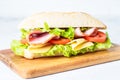 Ciabatta sandwich with lettuce, cheese, tomatoes and ham. Royalty Free Stock Photo