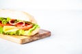 Ciabatta sandwich with lettuce, cheese, tomatoes and ham. Royalty Free Stock Photo