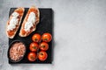 Ciabatta toasts with stracciatella cheese, chopped tomatoes and basil. White background. Top view. Copy space Royalty Free Stock Photo