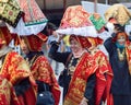 Group of Asian women wearing traditional minangkabau ethnic costume in wedding ceremony carrying offering goods on their head.