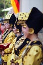 Group portrait of young Asian women wearing traditional minangkabau ethnic costume lined up in wedding ceremony