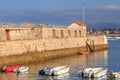 Ciboure, France - Sept 26, 2016: Fortification of the old marina of ciboure with a few walkers. There is pleasure boat in the fore