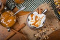 Selective focus on cup with whipped cream and drizzled caramel s