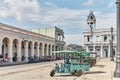 Historic center of city Cienfuegos, Cuba. Taxi motorcycles with passenger body. House of Culture